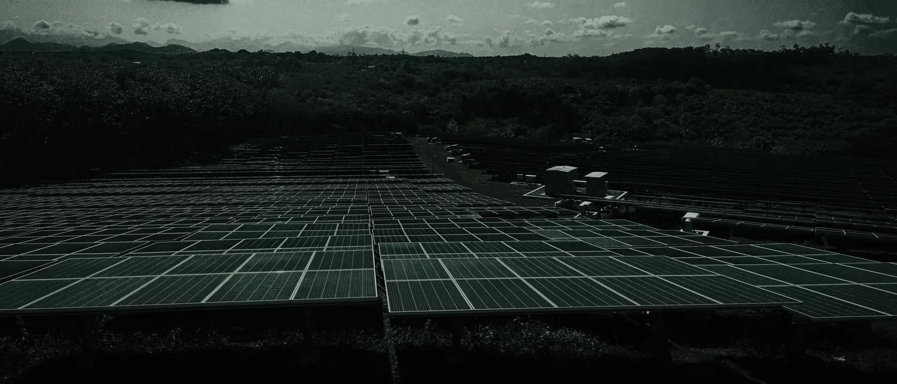 Utility-scale photovoltaic plant with inverter stations in open terrain
